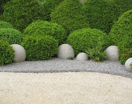 "Gardendesign with buxus balls, yew  and stone balls"